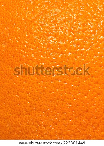 Texture of a bright orange peel closeup