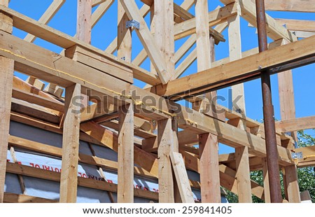 Installation of wooden beams at construction of the frame house
