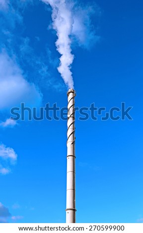 High factory chimneys over blue sky background