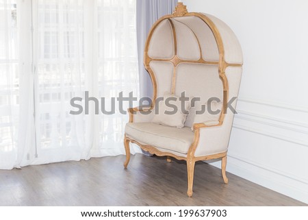 Antique armchair in white room with curtain background