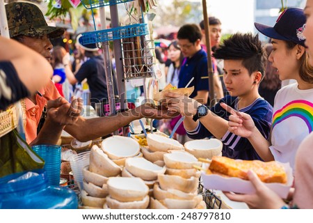 BANGKOK - JAN 25: Coconut Juice vendor in weekend bazaar on January 25, 2015 in Chatuchak Market, Bangkok is the world largest weekend market covering 27acre with 15,000 booths