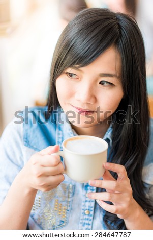 Beautiful cute girl in the cafe hold white coffee cup, Smiling asian woman