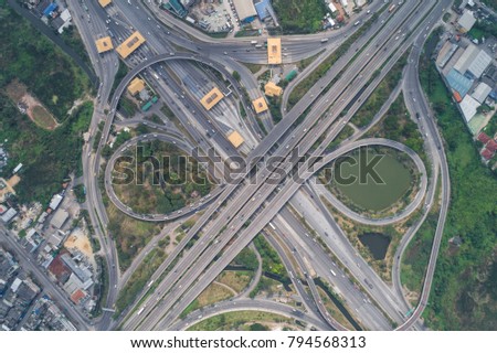 Overpass freeway intersection road with green tree and car movement aerial view