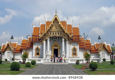 Buddhist temple in Bangkok. People faces blurred.