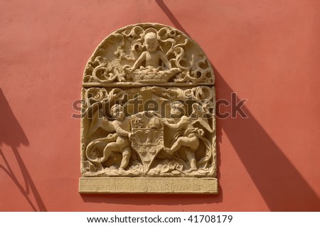 Stone emblem relief from ancient house facade. Old town Krakow in Poland.