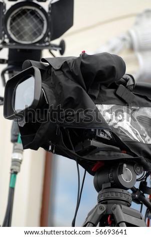 Professional TV camera with all weather cover awaiting action.