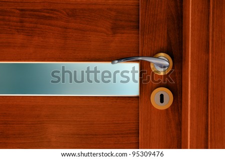 Interior wooden door to the room with frosted glass and  metal handle with lock.