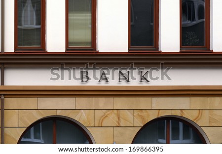 Small branch bank facade detail. No logo, only BANK letters.