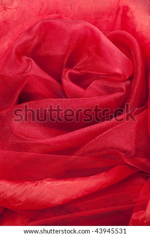 4 different red fabrics as one background, folded into abstract rose shape