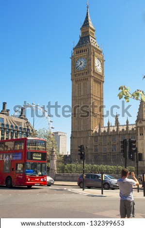 LONDON, MAR. 20: Typical red double-decker bus that passes in front of Big Ben in London on March 20, 2013. Both the red double-decker bus and Big Ben are symbols of London.