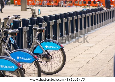 LONDON - SEPT 28: Row of hire bikes lined up in a docking station in London, on September 28, 2013. This bicycle sharing system was first introduced in London in July 2010.