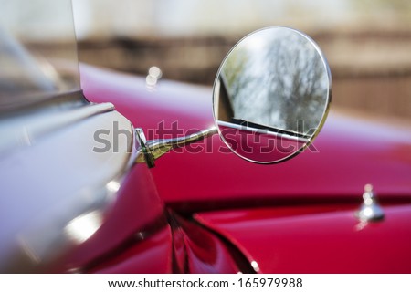 Closeup on an old 1970s French car Citroen side view mirror.