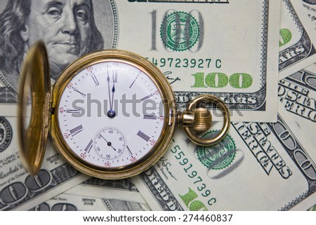 Time Is Money-Stopwatch laying on Money