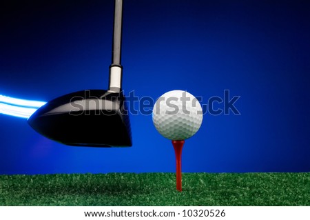 Image of a Light streak trailing Golf wood about to strike ball