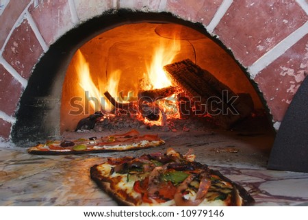 an image of pizza in a wood burning oven