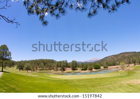 An image of a Arizona golf course with lush vegetation and mountain peaks