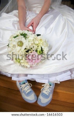 An image of a bride dressed in gown and tennis shoes