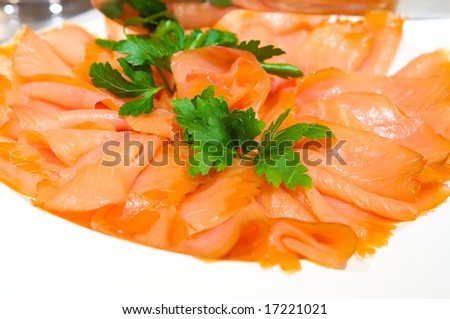 An image of decadent thinly sliced smoked salmon with garnish