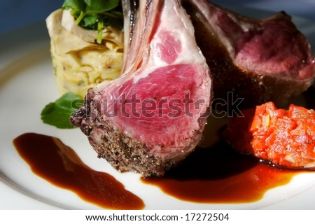 An image of gourmet lamb chops with garnishes
