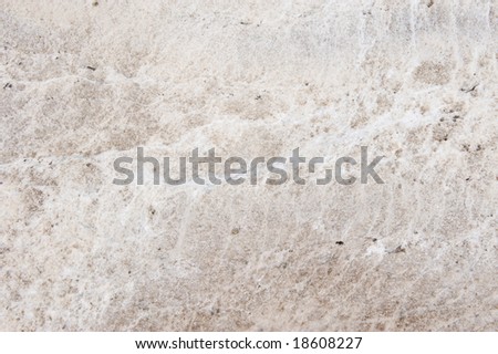 white granite counter with brown throughout it