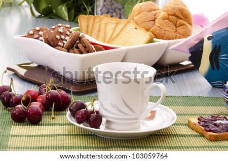 breakfast with cherry jam, tea and biscuits