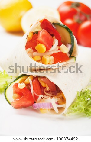 Vegetarian tortilla wraps with tomato, corn and lettuce