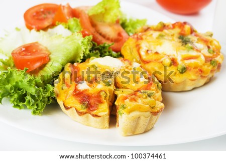 Mini quiche, vegetable pie served with tomato and lettuce salad