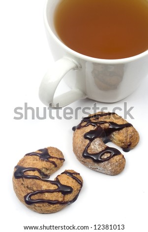 Two homemade chocolate glazed cookies and a cup of tea