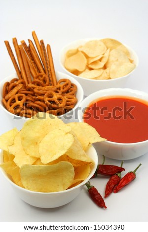 Salty snacks, potato chips and tomato dipping sauce