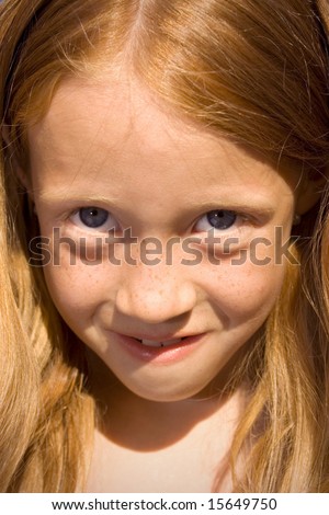 Young redhead girl portrait with a smile