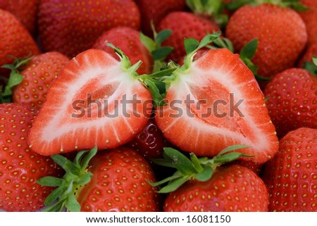 Fresh strawberry fruit cut in half close-up image