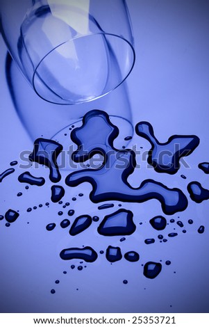 Blue toned image of water spilled from a glass