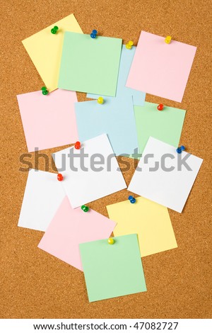 Cork notice board with blank paper notes
