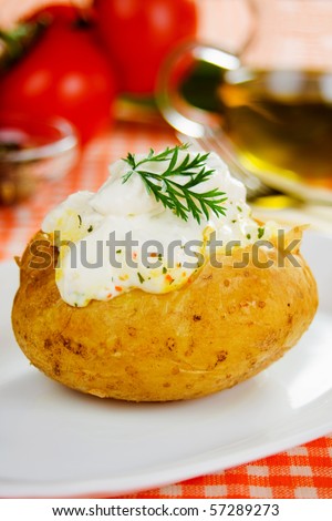 Baked potato with white sour cream sauce