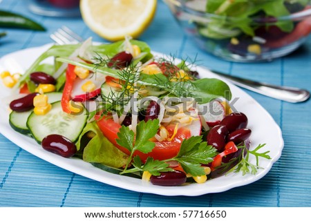 Healthy beans and vegetables salad on white plate