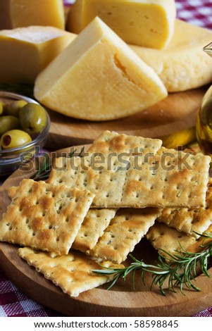 Salty cracker with hard cheese and rosemary