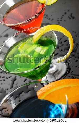 Green refreshing fruit drink in cocktail glass
