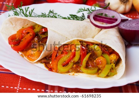 Vegetarian tortilla wraps filled with fried peppers