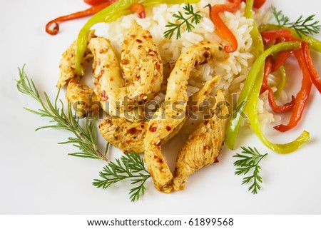 Spicy asian chicken meat with cooked rice and peppers
