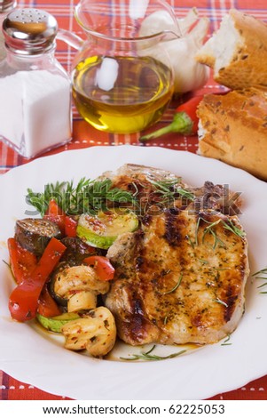 Grilled pork loin chops with mushrooms and vegetables