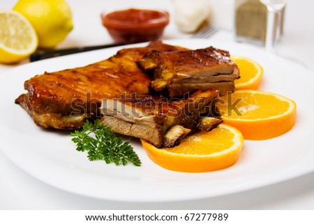 Barbecued honey glazed ribs with orange slices