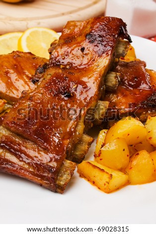 Delicious barbecued honey glazed ribs with baked potato