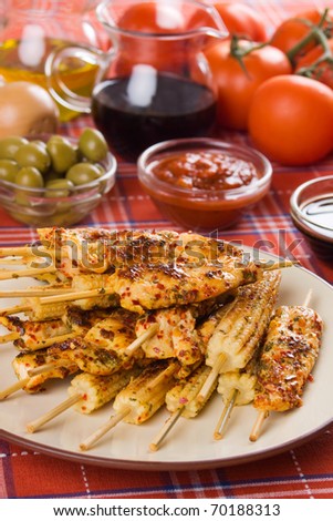 Spicy grilled chicken white meat and baby corn on skewer