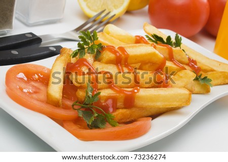 French fries, fried potato served with tomato and ketchup