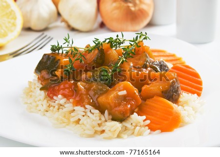 Zucchini and other vegetables in sauce served over cooked rice