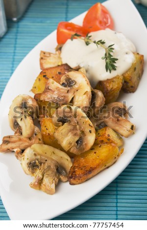 Champignon mushrooms served with potato and white sauce