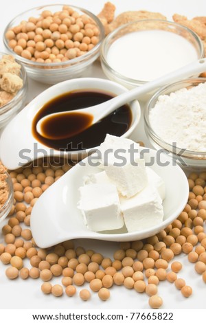 Tofu, soy-sauce and other soy products over white background