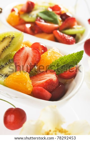 Fresh colorful fruit salad with strawberry, kiwi, cherry and orange