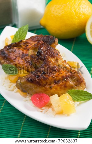 Caribbean style grilled chicken wings with rice and tropical fruit