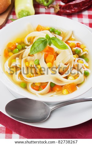 Healthy noodle soup with carrot, green peas and corn